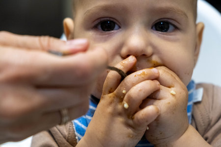 Baby Feeding Time with Messy Faceの写真素材