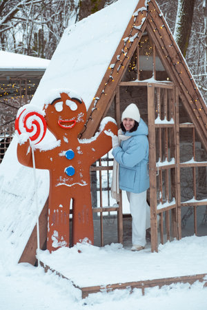 Woman Enjoying Winter with Gingerbread Man Decorationの写真素材