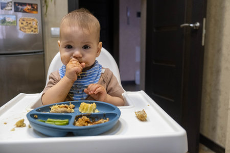 Baby Eating in High Chair with Divided Plateの写真素材