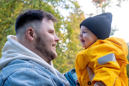 Father and Child Bonding in Autumn Parkの写真素材