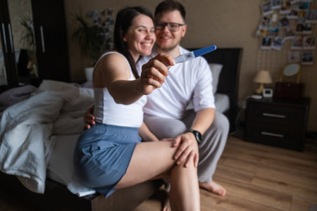 Happy Couple Celebrating Positive Pregnancy Testの写真素材