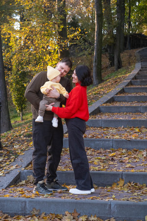 Happy Family in Autumn Parkの写真素材