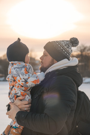 Father and Baby Bonding in Winter Sunsetの写真素材