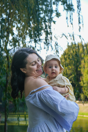 Joyful Mother and Baby by the Lakeの写真素材