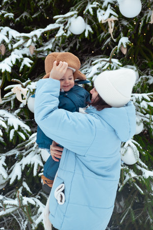 Winter Family Bonding by Snowy Christmas Treeの写真素材