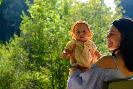 Mother and Baby Enjoying Sunny Day in Parkの写真素材