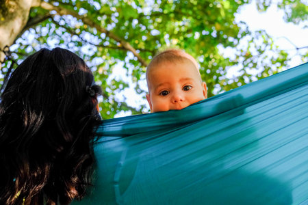 Child Peeking Over Hammock in Parkの写真素材