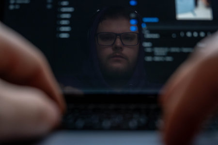 Man Reflection on Laptop Screen with Typing Hands