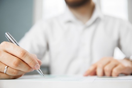 Business person analyzing financial statistics displayed on the tablet