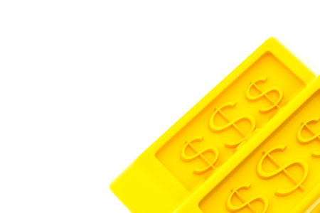 Shiny gold ingots on a white backgroundの写真素材