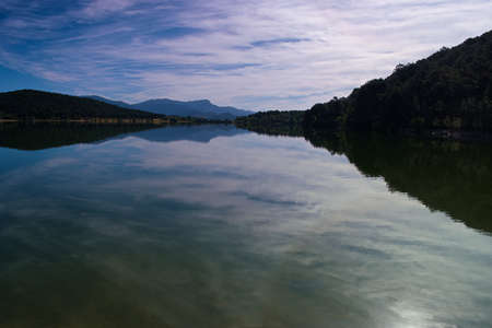 landscape lake view water embalse de la jarosa madrid trees mountains sky cloudsの写真素材