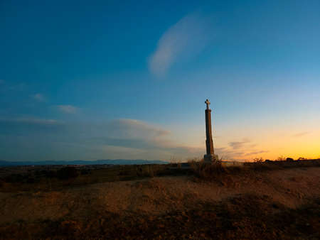 cross landscape morning sky clouds grassの写真素材