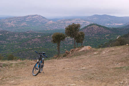 bike landscape mountains sky clouds trees viewの写真素材