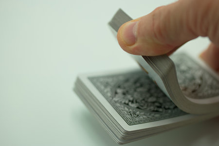 Closeup shot of a hand holding a tarot cards on a white backgroundの写真素材