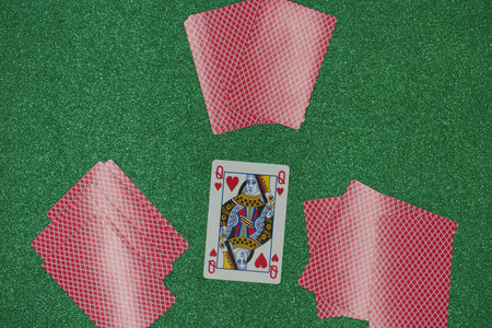 Playing cards on a green background, close-up, top view
