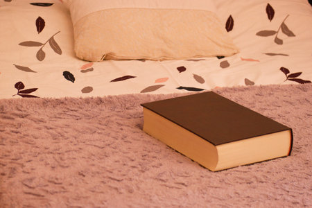 Book on the bed in the bedroom, close-up photo.