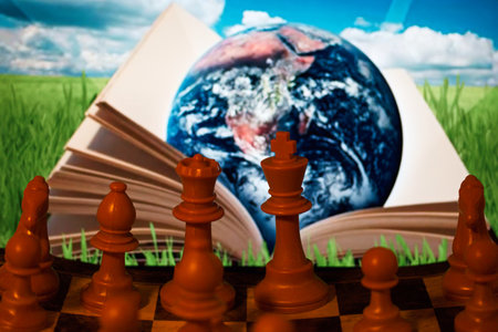 chess on the background of the earth and a book. concept of educationの写真素材