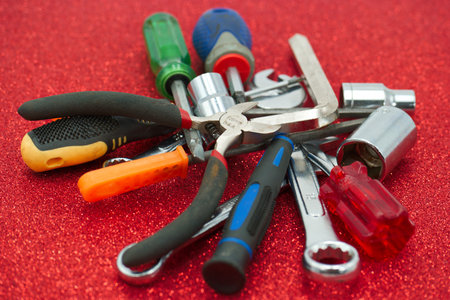 A set of tools for repair on a red background close-upの写真素材