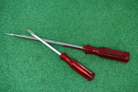 Screwdrivers on a green background, close-up of photo