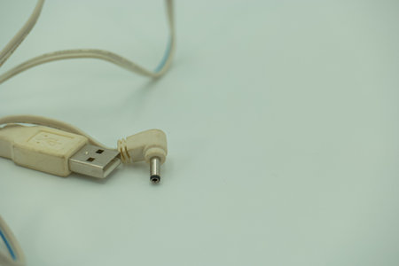 Close up of white USB cable on white background with copy space.