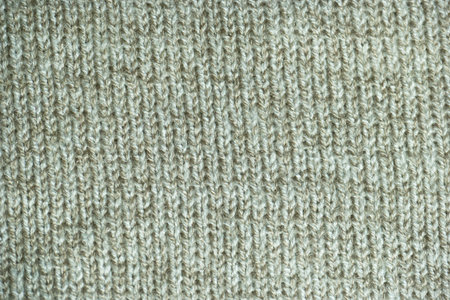 Knitted woolen texture. Knitted fabric background. Close-up.