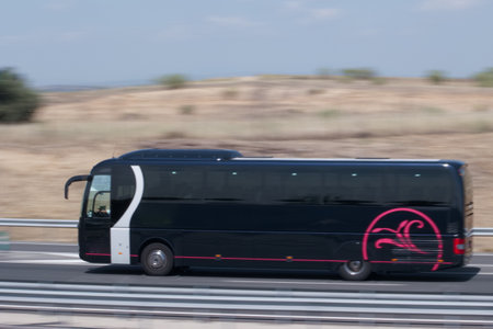 Bus on motorway in Spain. The bus is driving along the highway.の写真素材