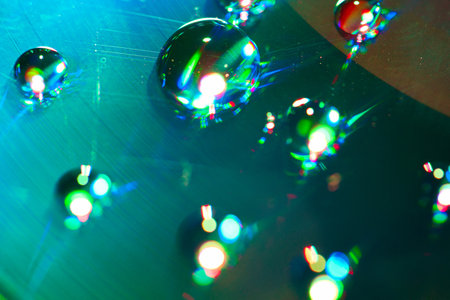 Close-up of colorful water drops on a CD/DVD.