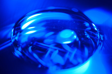 Close-up of a crystal ball with blue light in the backgroundの写真素材