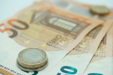 Euro banknotes and coins, close-up, shallow depth of fieldの写真素材