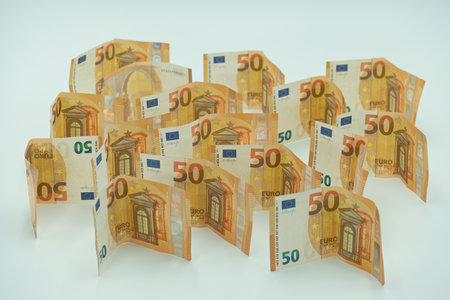 Euro banknotes in the shape of a speech bubble on a white backgroundの写真素材