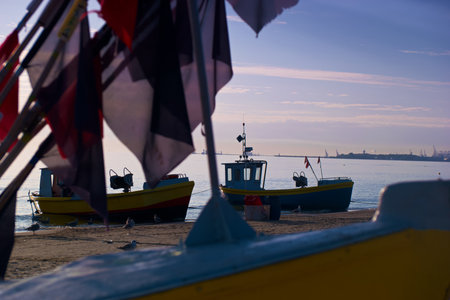 Fishing boats on the beach at sunset in Gdynia, Polandの写真素材