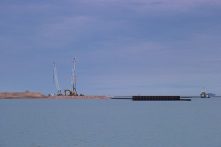 Cargo ship in the sea on a background of blue sky.