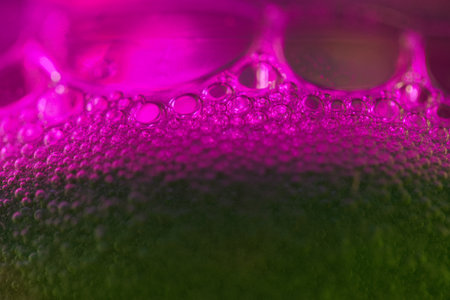 close up of water bubbles in pink and green color, abstract backgroundの写真素材