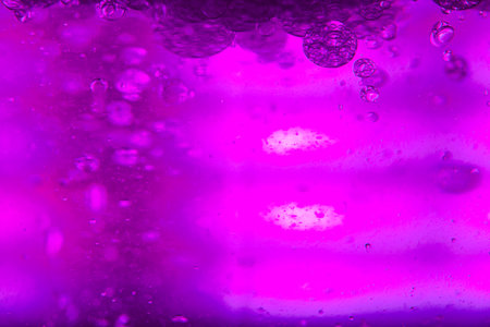 abstract background with pink and purple water droplets on the glass