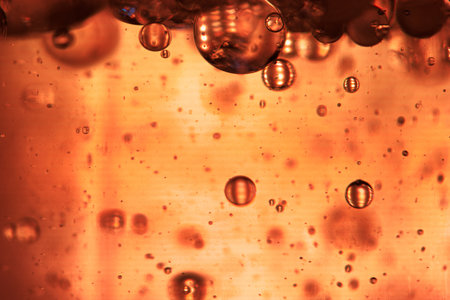 Bubbles in water on a orange background. Close-up.の写真素材