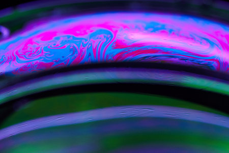 abstract colorful background, macro photo of oil drops on water surfaceの写真素材