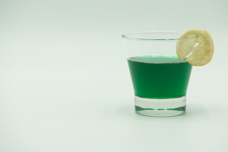 Cocktail with lemon and mint on white background, soft focus