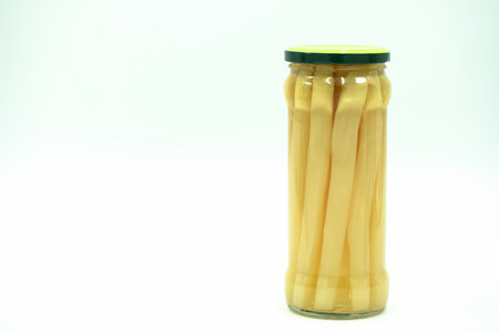 Canned mushrooms in a glass jar on a white background, isolateの写真素材