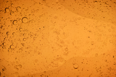 Water droplets on a yellow background. Shallow DOF.