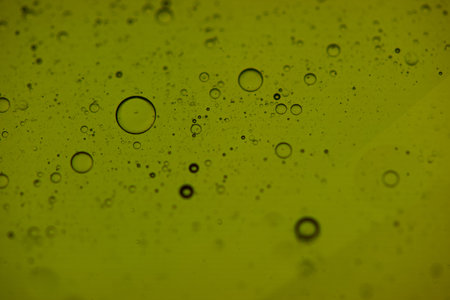 Water drops on green background. Abstract water drops on yellow background.の写真素材
