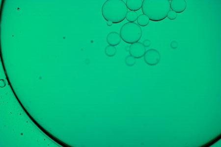 Close up shot of bubbles in water. Green background. Abstract background.の写真素材