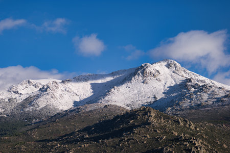 ...View of the Sierra de Guadarrama mountain range near Madrid in Spain with winter sky in the backgroundの写真素材