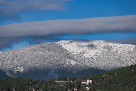 ...View of the Sierra de Guadarrama mountain range near Madrid in Spain with winter sky in the backgroundの写真素材