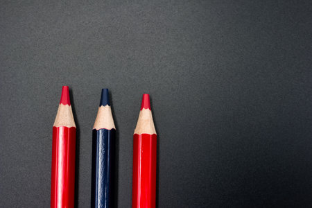 ...wooden colored pencils red and blue close-up on a plain background