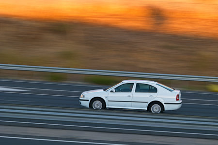 passenger car in motion with blurred background in the morningの写真素材