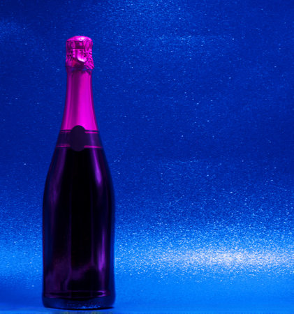 new year or special occasion champagne isolated on colorful shiny backgroundの写真素材