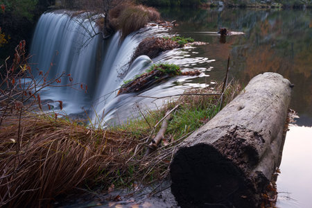 autumn river flowing in the mountains near madrid in the morning