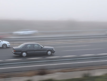 view of a car in motion in the morning fogの写真素材