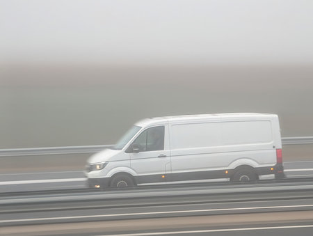 view of a car in motion in the morning fogの写真素材