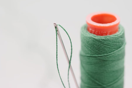 sewing threads and materials cut off on a white backgroundの写真素材